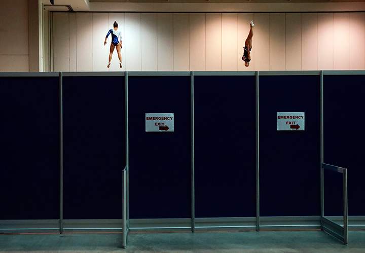 Brazil’s Camilla Lopes, left, and the United States’ Charlotte Drury warm up on trampolines behind a partition before women’s trampoline competition at the Pan Am Games in Toronto, Sunday, July 19, 2015.