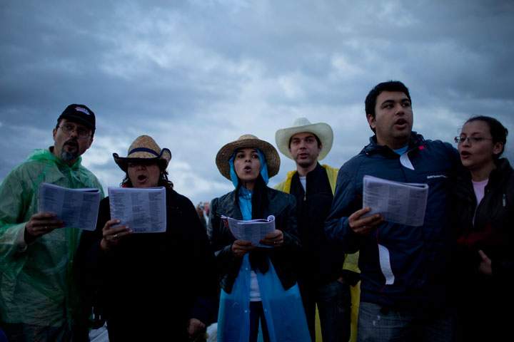 People sing as they wait to Pope Francis' arrival to the Nu Guazu field to celebrate a mass in Asuncion, Paraguay, Sunday, July 12, 2015. 