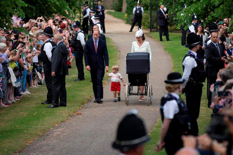 Britain’s Prince William, Kate the Duchess of Cambridge, their son Prince George and daughter Princess Charlotte in a pram arrive for Charlotte’s Christening at St. Mary Magdalene Church in Sandringham, England, Sunday, July 5, 2015.