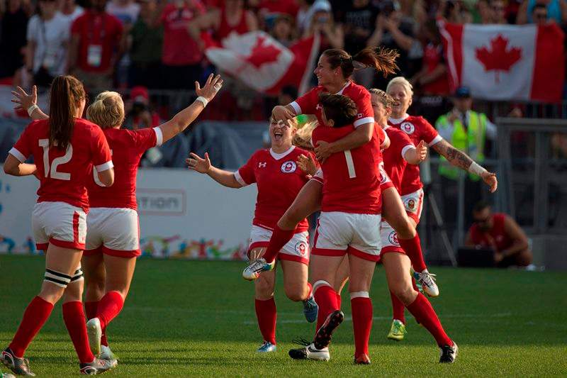 Ashley Steacy jumps into the arms of teammate Brittany Benn after winning Pan Am Games gold.