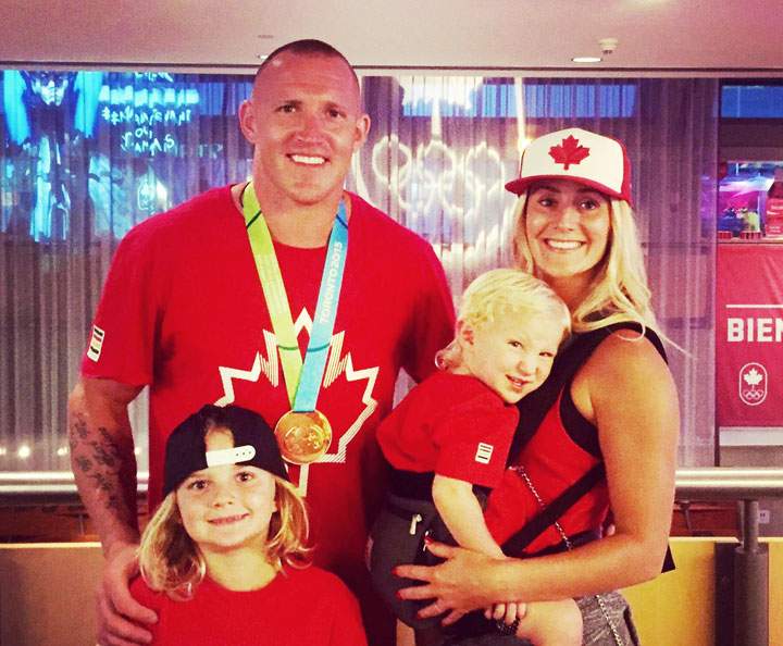 Malinoski posing with his family after winning gold at the 2015 Pan Am Games in Toronto.