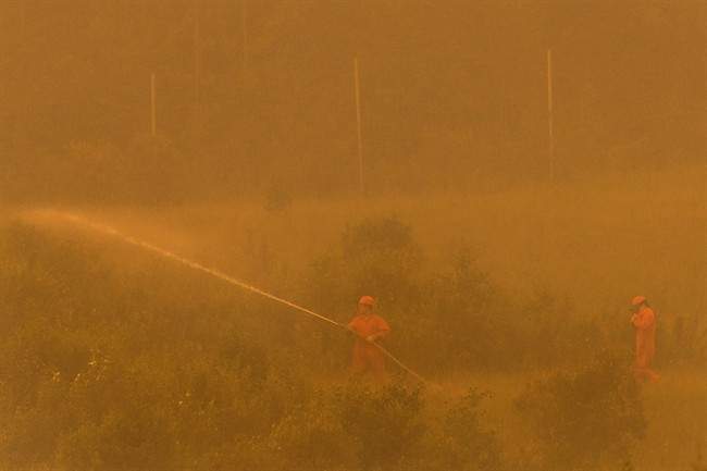 A firefighting crew is seen in the La Ronge, Sask., area in this July 5, 2015 handout photo. About 1,000 wildfire evacuees able to go home as evacuation order lifted for Pinehouse.