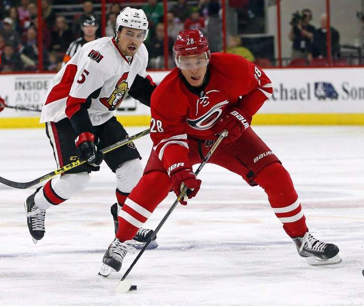 Carolina Hurricanes' Alexander Semin (28) brings the puck up the ice after taking it away from Ottawa Senators' Cody Ceci (5) during the second period of an NHL hockey game, Tuesday, March 17, 2015, in Raleigh, N.C.