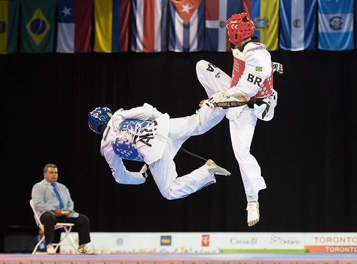 Lucas Guzman, left, of Argentina fights Venilton Torres of Brazil in the taekwondo men’s 58kg bronze medal match during the Pan American Games in Toronto on Sunday, July 19, 2015.