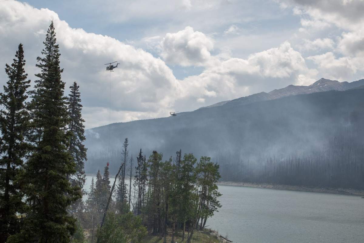 Two helicopters monitoring wildfire conditions.