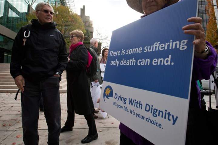 Hollis Johnson, left, and his wife Lee Carter leave the B.C. Court of Appeal after the court reversed a lower court ruling that said Canada's assisted-suicide ban violated the charter rights of gravely ill Canadians, in Vancouver, B.C., on Thursday October 10, 2013. 