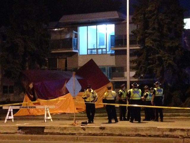 Edmonton police stand at the scene of a fatal collision on Whyte Ave., Wednesday, July 8, 2015.