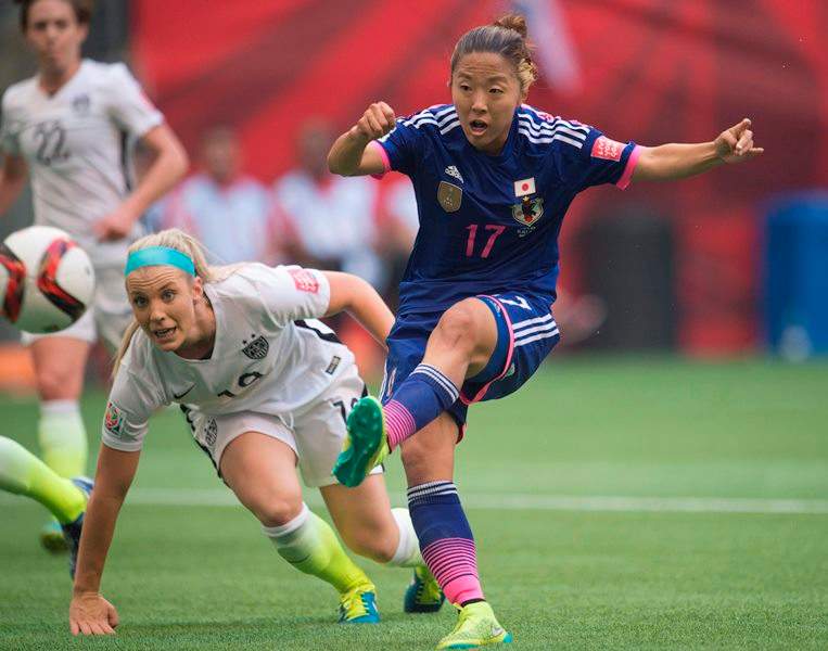 Japan’s Yuki Ogimi, right, scores a goal as United States’ Julie Johnston looks on during the first half of the final of the FIFA World Cup soccer action in Vancouver, B.C. Sunday, July 5, 2015.