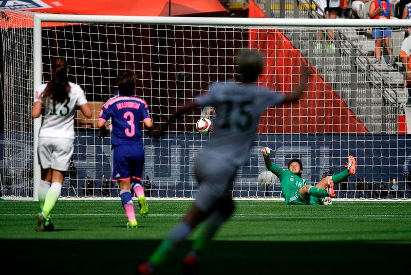 Japan’s goalkeeper Ayumi Kaihori, right, goes down after failing to save a goal scored by United States’ Carli Lloyd during the first half of the FIFA Women’s World Cup soccer championship in Vancouver, British Columbia, Canada, Sunday, July 5, 2015.