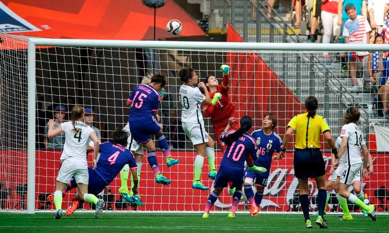 United States goalkeeper Hope Solo (1), center, punches away a shot from Japan during the second half of the FIFA Women’s World Cupsoccer championship in Vancouver, British Columbia, Canada, Sunday, July 5, 2015.