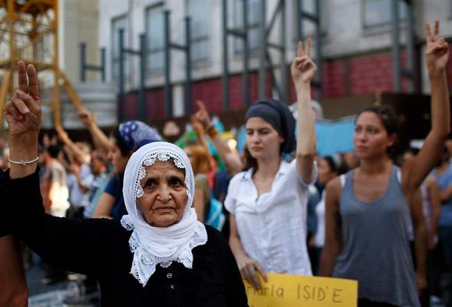 People raise their fists during a protest in Istanbul, Monday, July 20, 2015 against the deaths of dozens of people in an explosion in southeastern Turkey. The mid-day explosion took place at a cultural center in Suruc, near the Syrian border on Monday, in what Turkish authorities said appeared to be an Islamic State-inspired suicide bombing. (AP Photo/Emrah Gurel).