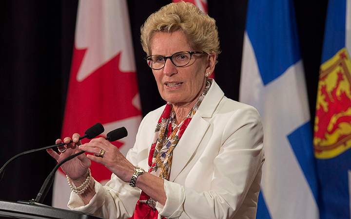 Ontario Premier Kathleen Wynne, pictured July 16, 2015, says her government's auto insurance rate target was a "stretch goal.".
