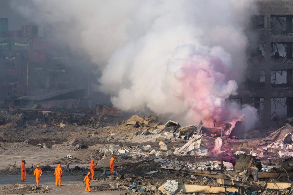 Huge, fiery blasts at a warehouse for hazardous chemicals killed many people and turned nearby buildings into skeletal shells in the Chinese port of Tianjin, raising questions Thursday about whether the materials had been properly stored. (AP Photo/Ng Han Guan)