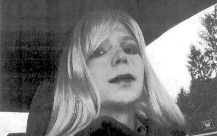 In this undated photo provided by the U.S. Army, Pfc. Chelsea Manning poses for a photo wearing a wig and lipstick.