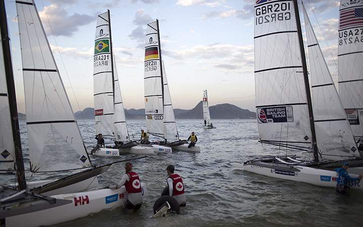 Athletes from the Nacra 17 Mixed Multihull class return to Flamengo beach after competing in a sailing test event for the Rio 2016 Olympic Games in Guanabara Bay, Rio de Janeiro, Brazil, Wednesday, Aug. 19, 2015.