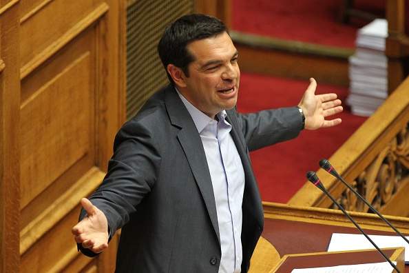 Greek Prime Minister Alexis Tsipras addresses the parliament during a vote on a bailout deal in Athens, Greece, on Friday, Aug. 14, 2015. Greek lawmakers approved their countrys draft third bailout in a parliamentary vote on Friday, August 14, 2015. (Photo by Ayhan Mehmet/Anadolu Agency/Getty Images).