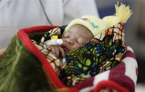 In this photo taken Tuesday, Aug. 11, 2015, Ebola survivor Victoria Yillia cradles her newborn son Barnabas at a maternity ward at the Kenema government hospital on the outskirts of Freetown, Sierra Leone.