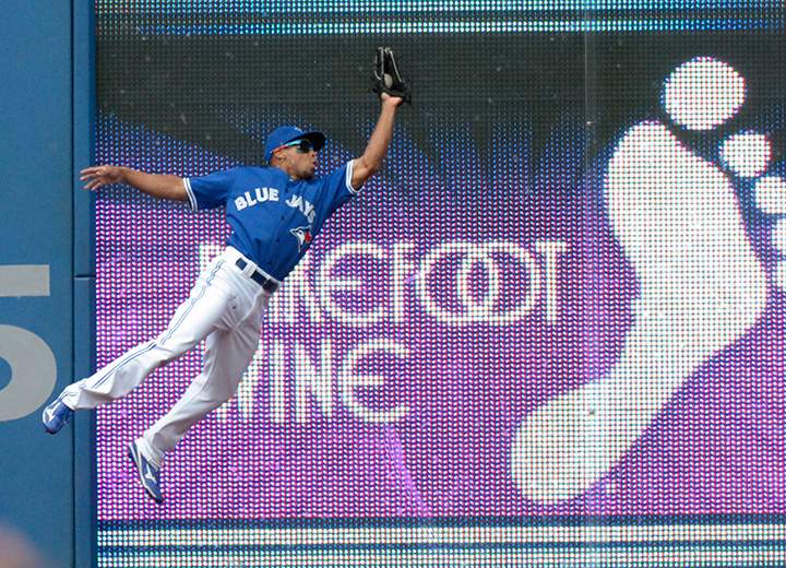 Toronto Blue Jays' Ben Revere catches a fly ball off the bat of Kansas City Royals' Kendrys Morales during the fourth inning on Saturday, August 1, 2015 in Toronto. 