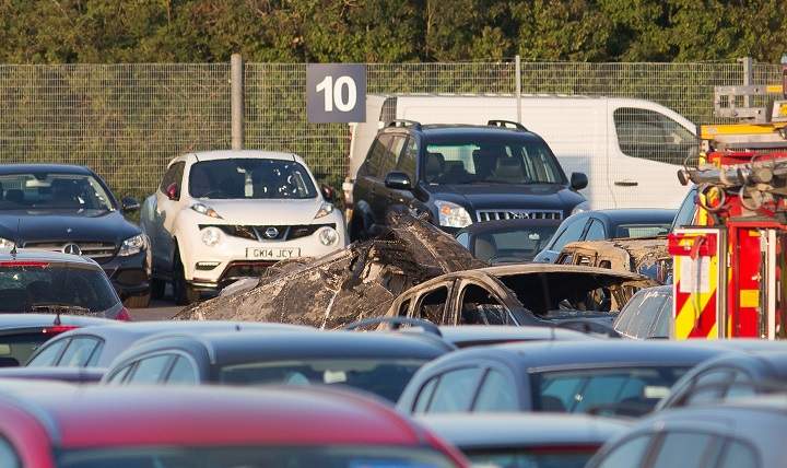 This picture taken on Friday, July 31, 2015, shows the debris of the Embraer Phenom 300 jet that crashed near the end of the runway of Blackbushe Airport, while trying to land at the airfield about 40 miles (65 kilometers) southwest of London.