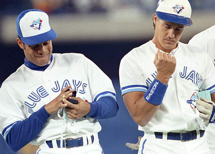 Toronto Blue Jays’ Roberto Alomar and teammate Pat Borders admire their Championship rings at the SkyDome in Toronto on April 9, 1993.