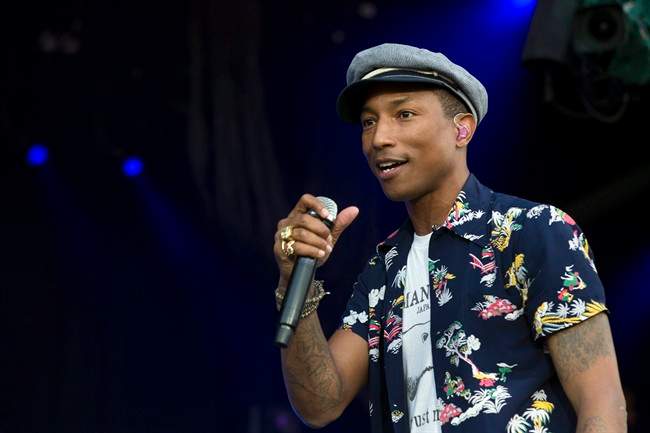 In this June 27, 2015 file photo, singer Pharrell Williams performs on the Pyramid Stage at Glastonbury music festival at Worthy Farm, Glastonbury, England. Williams, One Direction and Florence   The Machine are going to appear at the Apple Music Festival next month. Apple announced Tuesday, Aug. 18, 2015, that the musicians will be among the headliners at the 10-night festival at London’s Roundhouse that begins Sept. 19. 