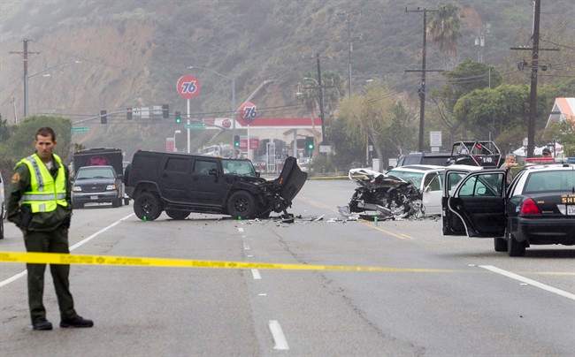 In this Saturday, Feb. 7, 2015 file photo, Los Angeles County Sheriff’s deputy guards the scene of a collision involving three vehicles in Malibu, Calif.