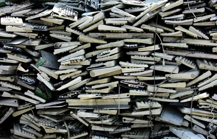 Discarded keyboards are piled up in a waiting area in Guiyu, China.