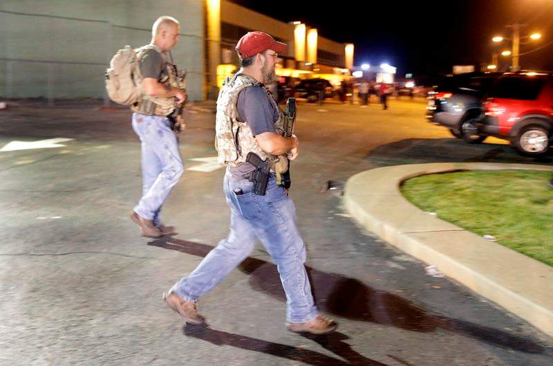 Heavily armed civilians with a group known as the Oath Keepers arrive in Ferguson, Mo., early Tuesday, Aug. 11, 2015.