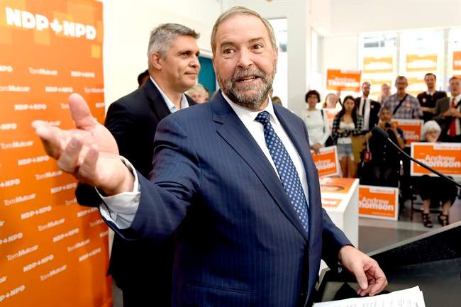 NDP Leader Tom Mulcair speaks to supporters along with candidate Andrew Thomson, left, during a campaign stop in Toronto on Thursday, August 27, 2015. 