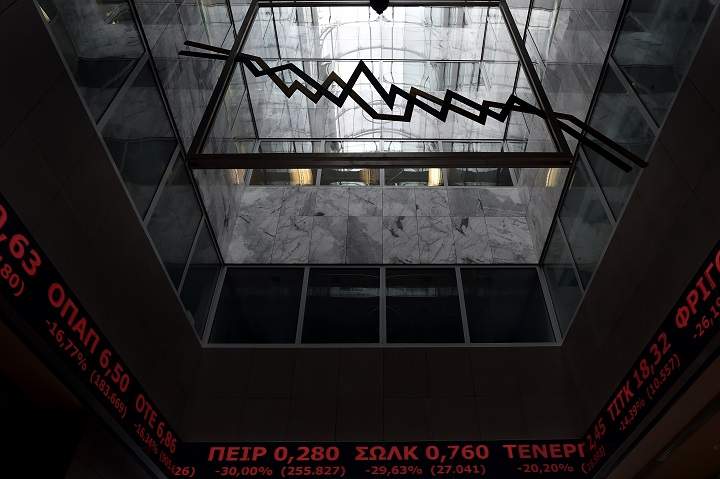 Stock index boards are pictured in the lobby of the Athens Stock Exchange in Athens on August 3, 2015. 