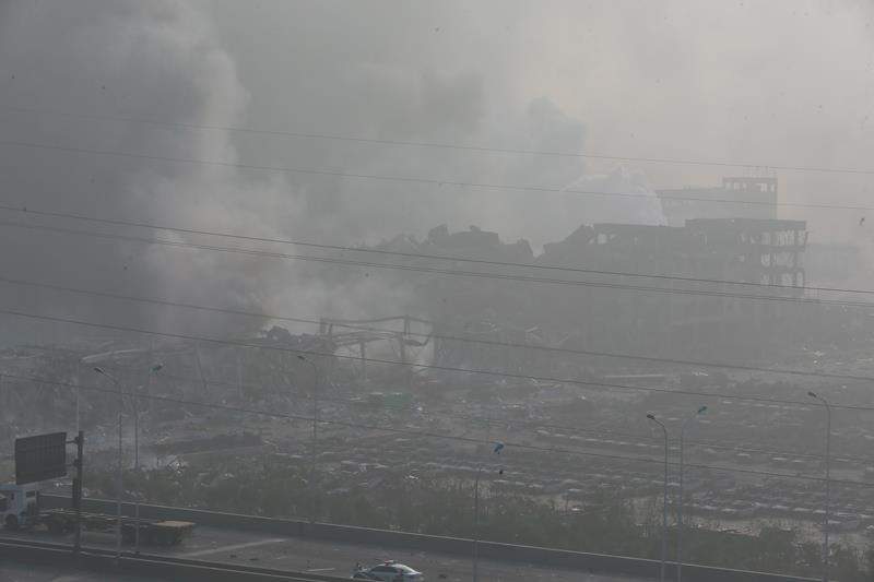 The accident site is still smoking after explosions of a warehouse on late Wednesday in Binhai New Area on August 13, 2015 in Tianjin, China.