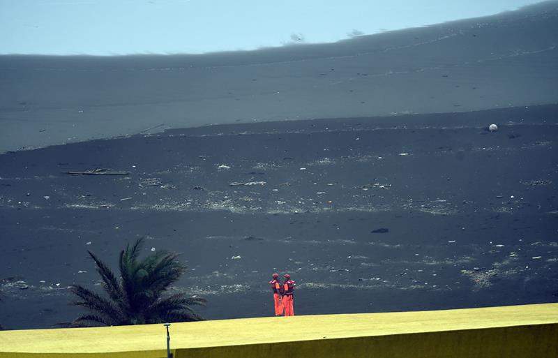 Two coast guards stand guard by the coast near the Wushih harbor in Yilan as typhoon Goni approaches in eastern Taiwan on August 22, 2015.