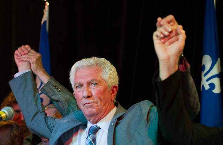Bloc Quebecois leader Gilles Duceppe has his arms raised by supporters during a federal election campaign stop in Montreal, Friday, August 7, 2015.