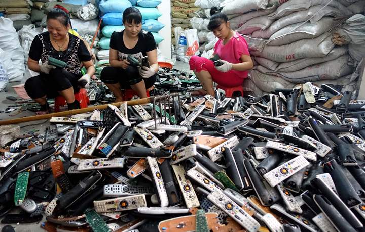 Workers dismantle electronics in Guiyu Township in Shantou City.