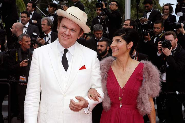 Actor John C. Reilly, left, and his partner Alison Dickey pose for photographers upon arrival for the awards ceremony at the 68th international film festival, Cannes, southern France, Sunday, May 24, 2015.