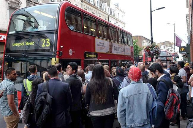 Passengers crowd around a bus stop outside Paddington Station in London, Thursday, Aug. 6, 2015. Commuters are having to find alternative methods of travel Thursday as the London tubes are not running due to a strike. London's mayor has ruled out offering more money to resolve a London Underground labor set to shut down services for the second time this summer. (AP Photo/Kirsty Wigglesworth).