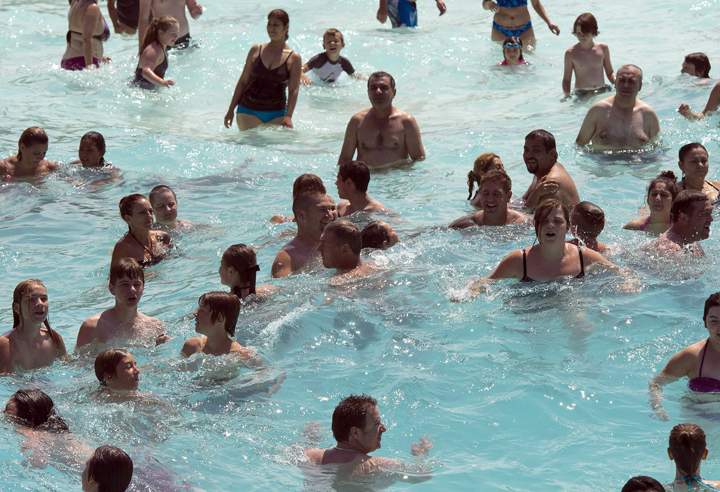 Bathers bob in the wave pool to beat the heat.