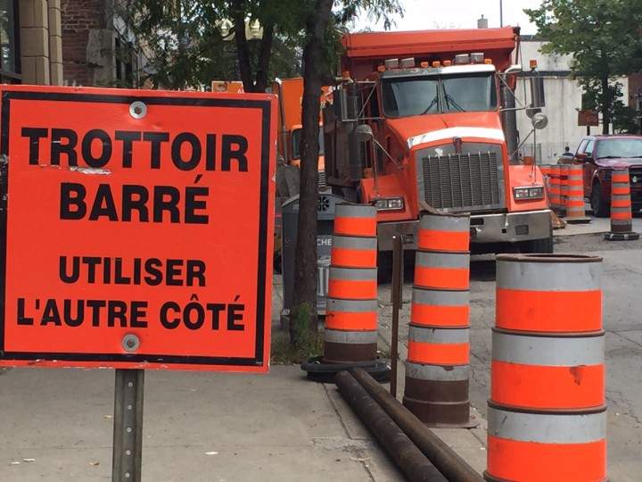 A sidewalk is blocked to make way for construction on Notre-Dame Street, Monday, August 31, 2015.