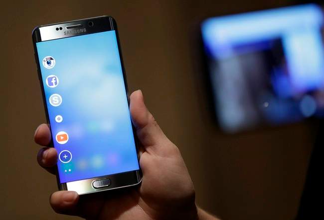 In this Aug. 6. 2015, photo, a Samsung employee displays the new Galaxy S6 Edge Plus in New York.