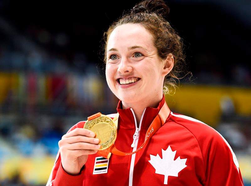 Morgan Bird of Canada shows off her gold medal after winning the women's S8 400m and the women's S8 50m during the Parapan Am Games in Toronto on Sunday, August 9, 2015. 
