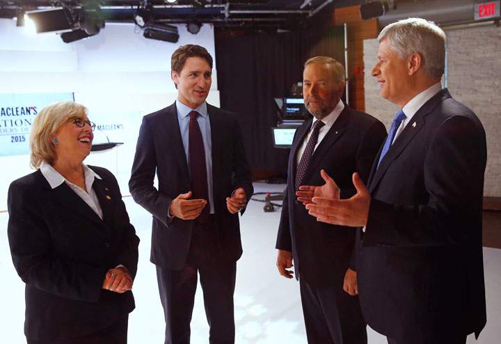 Canada's Green Party leader Elizabeth May, Liberal leader Justin Trudeau, New Democratic Party leader Thomas Mulcair and Conservative leader Stephen Harper confer before a leaders' debate in Toronto, August 6, 2015.