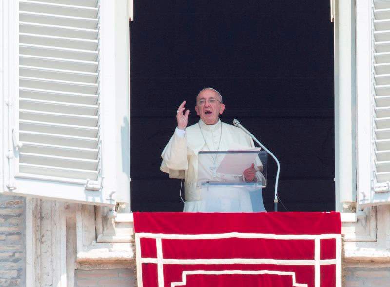 Pope Francis recites the Angelus noon prayer from his studio window overlooking St. Peter's Square at the Vatican, Sunday, Aug. 9, 2015. Pope Francis said the detonation of atomic bombs at Hiroshima and Nagasaki 70 years ago remains "a permanent warning to humanity" to reject war and ban weapons of mass destruction. 