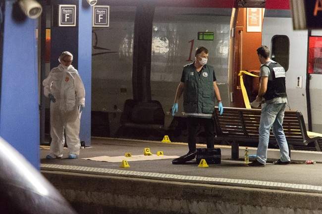 Police officers investigate on a platform next to a Thalys train at Arras train station, northern France, Friday, Aug. 21, 2015. 