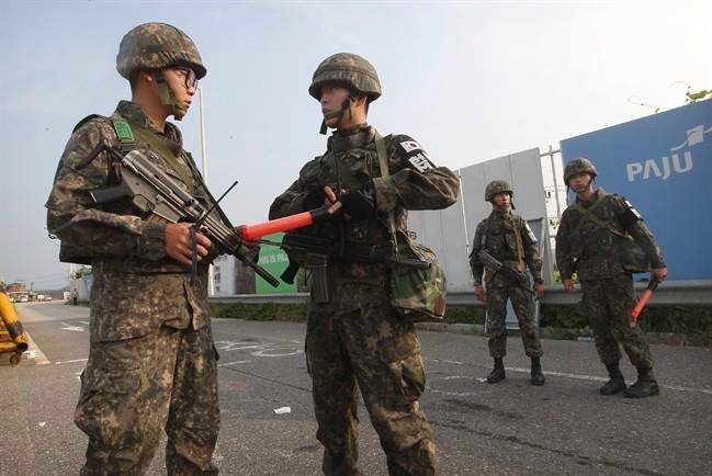 South Korean army soldiers stand guard on Unification Bridge, which leads to the demilitarized zone, near the border village of Panmunjom in Paju, South Korea, Monday, Aug. 24, 2015. 