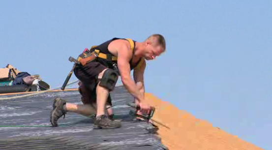 Rapid Roofing Solutions’ Ryan McClelland shingles roof in Saskatoon during August heat wave.