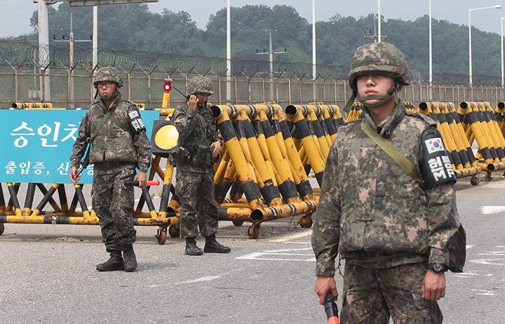 South Korean army soldiers stand guard at Unification Bridge near the border village of Panmunom in Paju, South Korea, Friday, Aug. 21, 2015. 