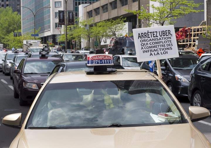 Taxi drivers hold a demonstration through the streets of downtown Montreal against the ride-sharing app Uber, Tuesday, May 19, 2015 in Montreal.