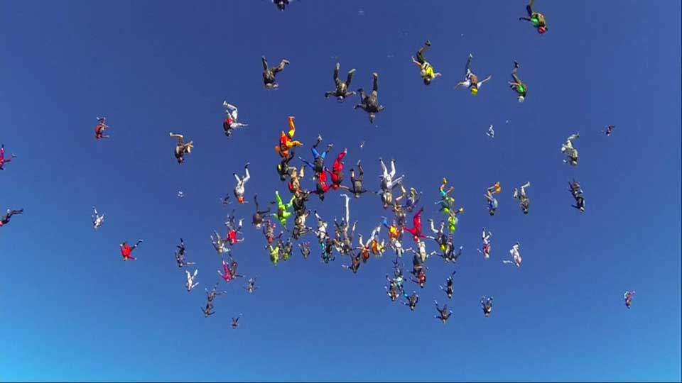 Four videographers joined the 164 colourful skydivers 6 km above the Earth to begin their descent.