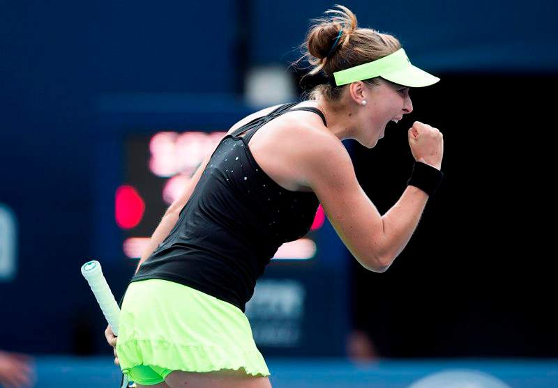 Belinda Bencic, of Switzerland, celebrates after winning the first set against Simona Halep, of Romania, during the women's final at the Rogers Cup tennis tournament in Toronto on Sunday, August 16, 2015.