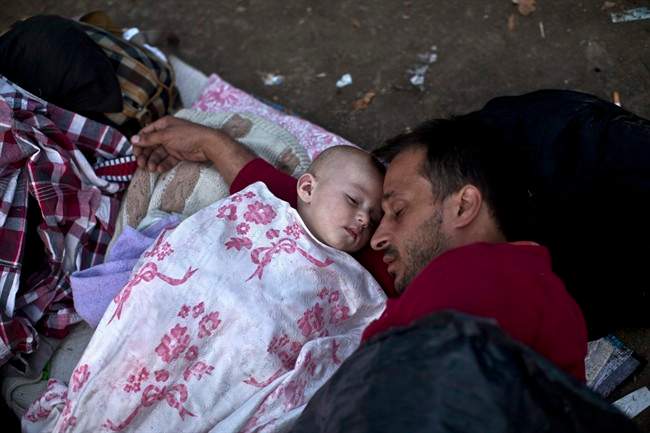 Migrants from Syria sleep at a park in Belgrade, Serbia, Thursday, Aug. 27, 2015. 